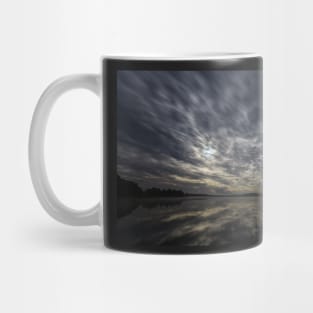 Dynamic clouds in the night over the lake lit by full moon Mug